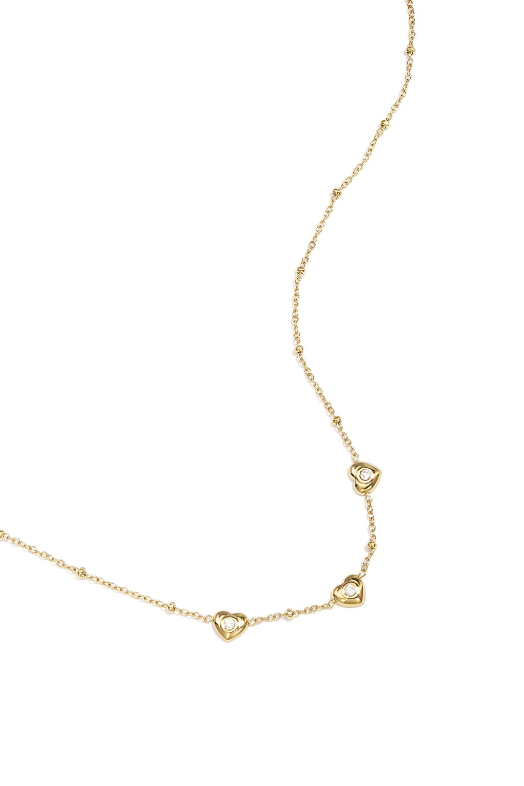 Ketting met bolletjes en hartjes met steen